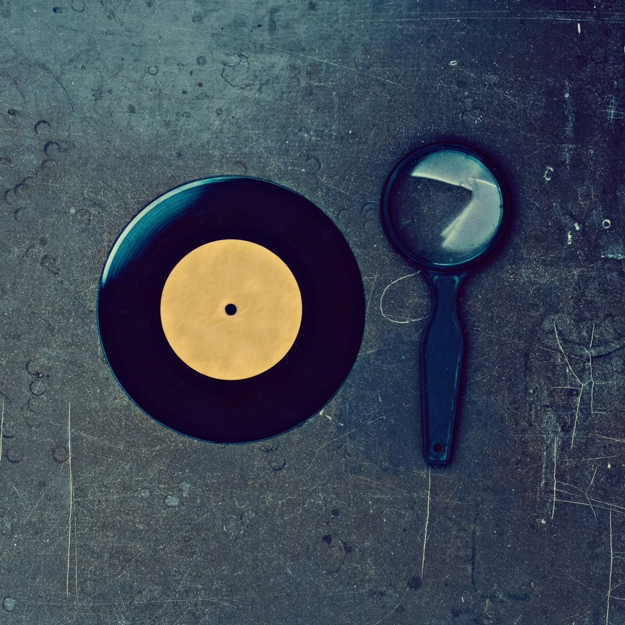 Vinyl Record And Magnifier On Wooden Table PMQWC